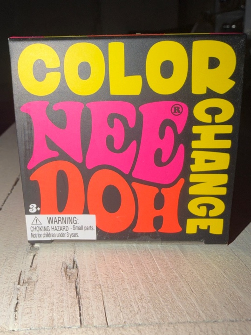 Color NEE DOH Color Change Toy - Black Box with Yellow, Pink, Orange Graphics